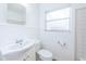 Clean bathroom with a sink, toilet, and window at 601 Paris S Ave, St Petersburg, FL 33701