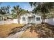 Newly renovated home with a white exterior and well-maintained lawn at 601 Paris S Ave, St Petersburg, FL 33701
