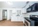 Modern kitchen with white cabinets, stainless steel appliances, and marble countertops at 601 Paris S Ave, St Petersburg, FL 33701