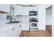 Modern kitchen with white cabinets, stainless steel appliances, and marble countertops at 601 Paris S Ave, St Petersburg, FL 33701