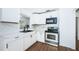 Modern kitchen with white cabinets, stainless steel appliances, and marble countertops at 601 Paris S Ave, St Petersburg, FL 33701