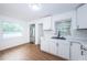 Modern kitchen with white cabinets, stainless steel appliances, and marble countertops at 601 Paris S Ave, St Petersburg, FL 33701