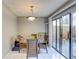 Dining area with a glass-top table and four chairs, near the kitchen and patio at 6262 142Nd N Ave # 505, Clearwater, FL 33760