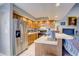 Kitchen with wood cabinets, double sink, and views of dining and living areas at 6262 142Nd N Ave # 505, Clearwater, FL 33760