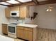 Kitchen with wood cabinets, tiled floors, and built-in microwave at 702 Dorado Ct, Brandon, FL 33511