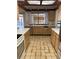 Kitchen with wood cabinets, tile floor, and view of backyard at 702 Dorado Ct, Brandon, FL 33511