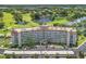 Aerial view of a condo building with golf course and water views at 8950 Park Blvd # 505, Seminole, FL 33777