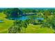 Aerial view of lush green golf course with lake at 8950 Park Blvd # 505, Seminole, FL 33777