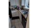 Small kitchen with white cabinets and granite countertops at 8950 Park Blvd # 505, Seminole, FL 33777