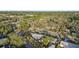 Aerial view showing the house's location on a tree-lined street at 1890 San Mateo Dr, Dunedin, FL 34698