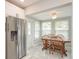 Cozy dining area with a wooden table and chairs near the kitchen at 1890 San Mateo Dr, Dunedin, FL 34698