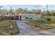 Charming single-story home with a landscaped yard and driveway at 1890 San Mateo Dr, Dunedin, FL 34698