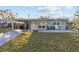 Light blue house with a covered patio and well-maintained lawn at 1890 San Mateo Dr, Dunedin, FL 34698
