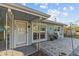 Front entry with a covered porch and a brick paved patio at 1890 San Mateo Dr, Dunedin, FL 34698
