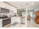 Updated kitchen boasts white cabinets, granite counters & stainless steel appliances at 1890 San Mateo Dr, Dunedin, FL 34698