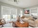 Living room with large windows, hardwood floors, and comfortable seating at 1890 San Mateo Dr, Dunedin, FL 34698