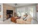Bright living room features wood-look floors, comfy sofa, and a wood accent wall at 1890 San Mateo Dr, Dunedin, FL 34698