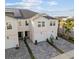 This aerial view shows a townhome with a paved driveway, solar panels, and well-maintained landscaping at 2391 Summerlit St, Lutz, FL 33558