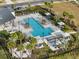 Relaxing community pool area featuring lounge chairs, shaded cabanas, and lush landscaping for resident enjoyment at 2391 Summerlit St, Lutz, FL 33558