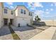 This is an eye-level exterior of a townhome with a private attached garage and paved driveway at 2391 Summerlit St, Lutz, FL 33558