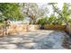 View of the backyard featuring a full wood fence and a partial shade from mature trees and a concrete pad at 3424 Queensboro S Ave, St Petersburg, FL 33711