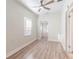 Bedroom with natural light from the window, a ceiling fan, and wood look flooring at 3424 Queensboro S Ave, St Petersburg, FL 33711