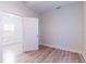 View of a bedroom featuring wood-look flooring, a ceiling fan, and an open door leading to another room at 3424 Queensboro S Ave, St Petersburg, FL 33711