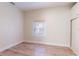 Bedroom showcasing bright natural light from the window and built-in storage, and wood look floors at 3424 Queensboro S Ave, St Petersburg, FL 33711