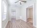 Bedroom with a ceiling fan, natural light, and wood look floors, featuring multiple entrances to other spaces at 3424 Queensboro S Ave, St Petersburg, FL 33711