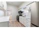 Updated kitchen featuring stainless steel appliances, white cabinetry, modern countertops, and updated flooring at 3424 Queensboro S Ave, St Petersburg, FL 33711