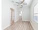 Bright living room featuring updated light gray vinyl flooring, fresh paint that leads into the kitchen at 3424 Queensboro S Ave, St Petersburg, FL 33711