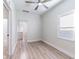 Bright living room featuring updated light gray vinyl flooring, fresh paint that leads into the kitchen at 3424 Queensboro S Ave, St Petersburg, FL 33711