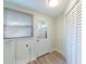 Mud room featuring a closet, access to outside and washer/dryer hookups, and wood look flooring at 3424 Queensboro S Ave, St Petersburg, FL 33711
