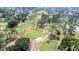 Aerial view of a golf course with lush green fairways and trees at 3466 Maclaren Dr, Palm Harbor, FL 34684