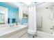 Clean bathroom with light blue walls and a shower/tub combo at 3466 Maclaren Dr, Palm Harbor, FL 34684