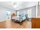 Bedroom with wood-look floors, ceiling fan and ensuite bathroom at 3466 Maclaren Dr, Palm Harbor, FL 34684