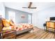 Bedroom with floral bedding, a work space and ceiling fan at 3466 Maclaren Dr, Palm Harbor, FL 34684