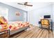 Bedroom with floral bedding, a work space and ceiling fan at 3466 Maclaren Dr, Palm Harbor, FL 34684