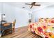 Bedroom with floral bedding, a work space and ceiling fan at 3466 Maclaren Dr, Palm Harbor, FL 34684