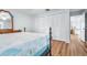 Bright bedroom with wood flooring and access to another room at 3466 Maclaren Dr, Palm Harbor, FL 34684