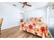 Bedroom with floral bedding, a work space and ceiling fan at 3466 Maclaren Dr, Palm Harbor, FL 34684