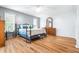 Spacious bedroom with wood-look floors, ceiling fan, and ensuite bathroom at 3466 Maclaren Dr, Palm Harbor, FL 34684