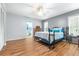 Bedroom with wood-look floors, ceiling fan and ensuite bathroom at 3466 Maclaren Dr, Palm Harbor, FL 34684