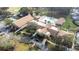 Community clubhouse with pool and surrounding landscape at 3466 Maclaren Dr, Palm Harbor, FL 34684