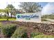 Highland Lakes Club entrance sign with stonework landscaping at 3466 Maclaren Dr, Palm Harbor, FL 34684