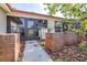 Inviting front entrance with brick accents, patio area, and meticulous landscaping at 3466 Maclaren Dr, Palm Harbor, FL 34684