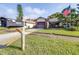 Charming single-story home with a well-manicured lawn and an American flag waving out front at 3466 Maclaren Dr, Palm Harbor, FL 34684