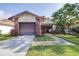 Charming home showcasing a brick facade, attached garage, and tidy front yard at 3466 Maclaren Dr, Palm Harbor, FL 34684