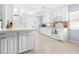 White kitchen with ample cabinet space and tiled floors at 3466 Maclaren Dr, Palm Harbor, FL 34684
