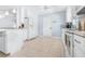 Bright kitchen with white cabinets, tile floors, and stainless steel appliances at 3466 Maclaren Dr, Palm Harbor, FL 34684